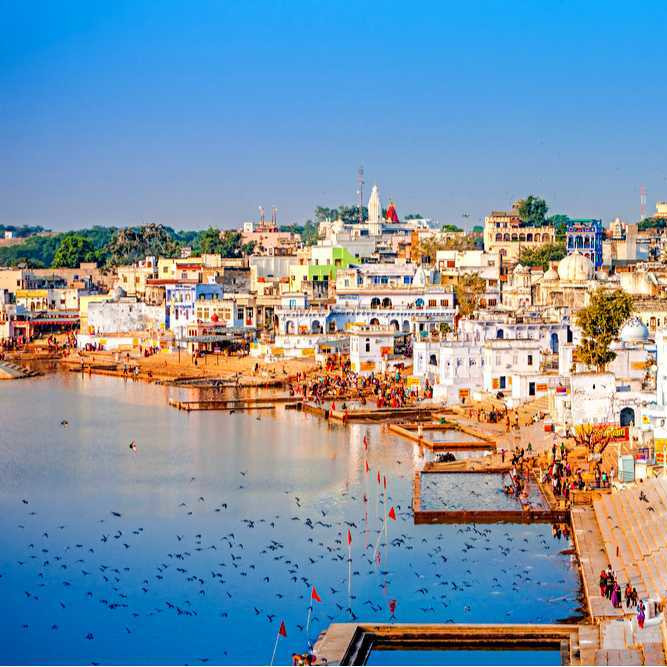 Pushkar Lake with travelers and temples