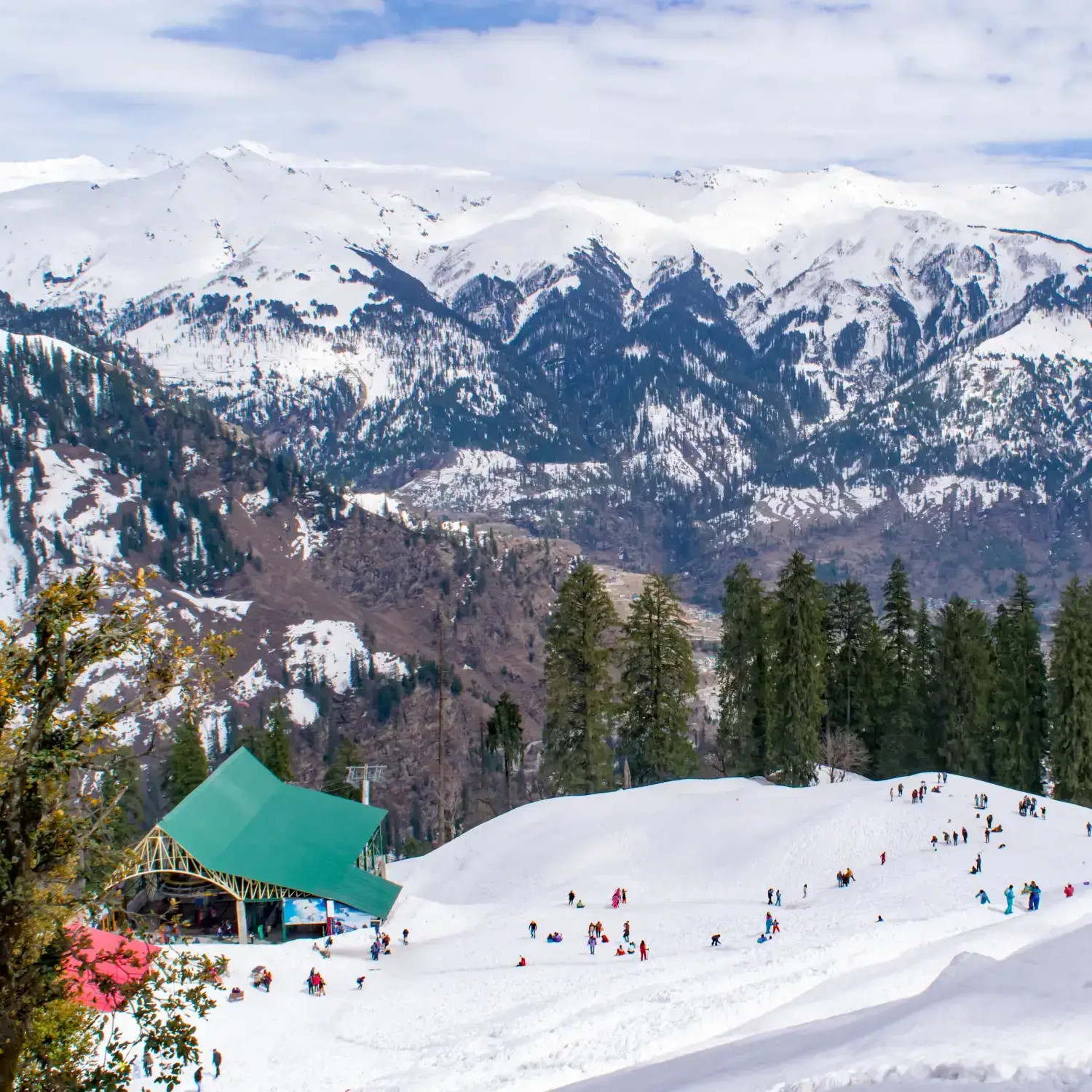 Snowy hill station with tourists on holiday