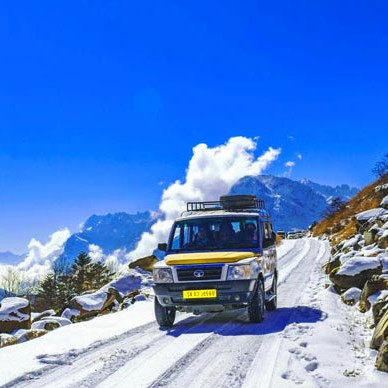 Tourist vehicle on snowy road – scenic travel