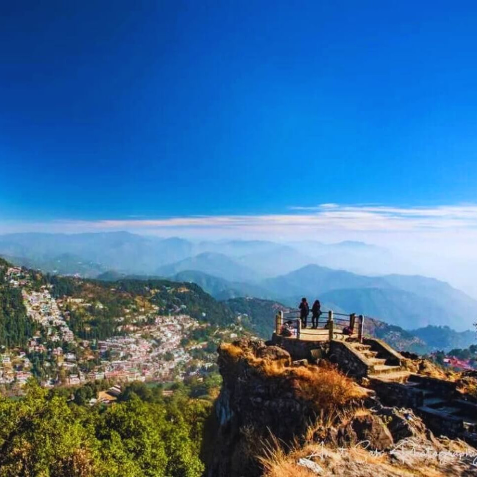 Tourists on cliff view – layered travel tour